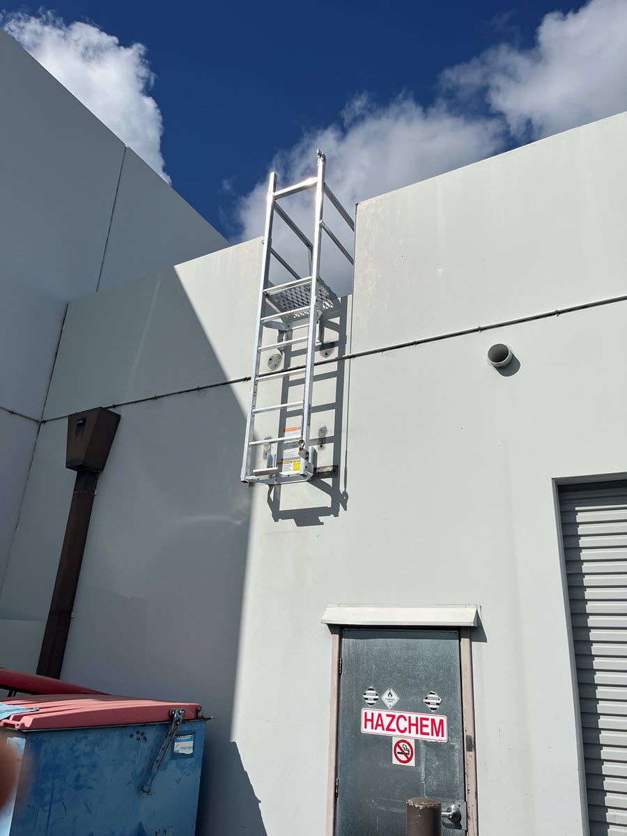Half way ladder access to roof installed in commercial warehouse.