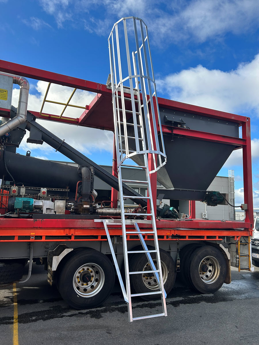 Large caged access ladder on side of truck.